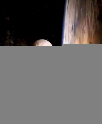A view of Earth from space with the moon visible and a colorful horizon.